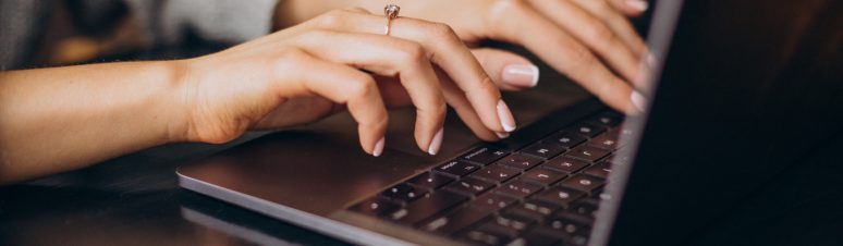 Female hands typing on computer keyboard